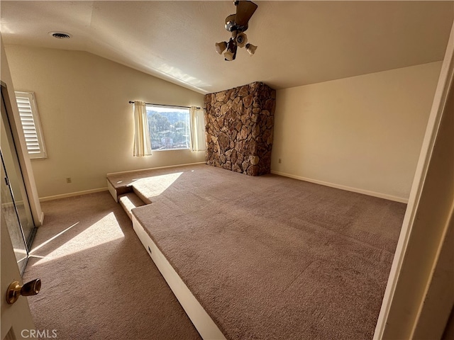 unfurnished living room featuring carpet floors and vaulted ceiling