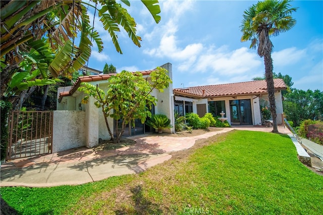 rear view of property with a lawn