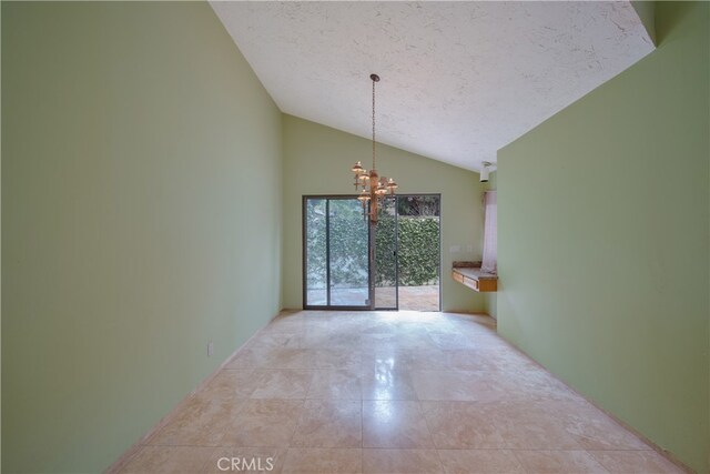 spare room with high vaulted ceiling, a chandelier, and a textured ceiling