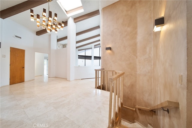 staircase featuring a notable chandelier, beam ceiling, and high vaulted ceiling