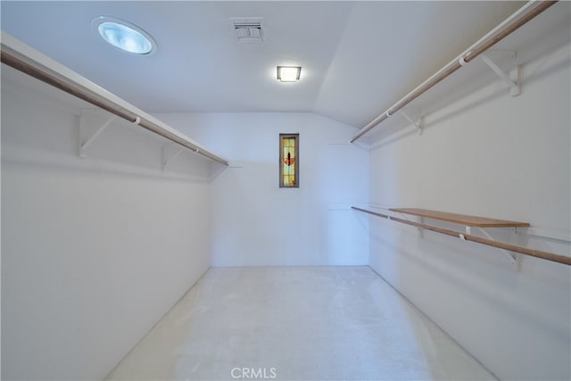 spacious closet featuring lofted ceiling and carpet floors