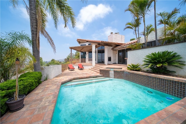 view of swimming pool with an in ground hot tub and a patio area