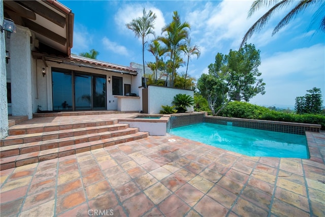 view of pool featuring an in ground hot tub and a patio area