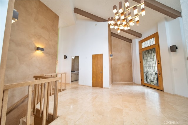 interior space with light tile patterned flooring, a chandelier, beam ceiling, and high vaulted ceiling