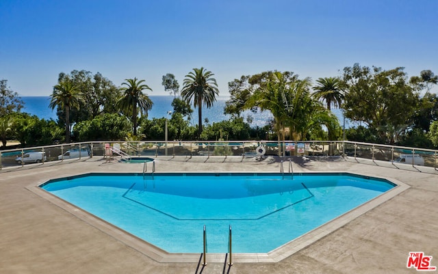 view of swimming pool featuring a water view