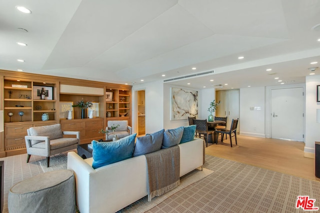 living room featuring light wood-type flooring and lofted ceiling