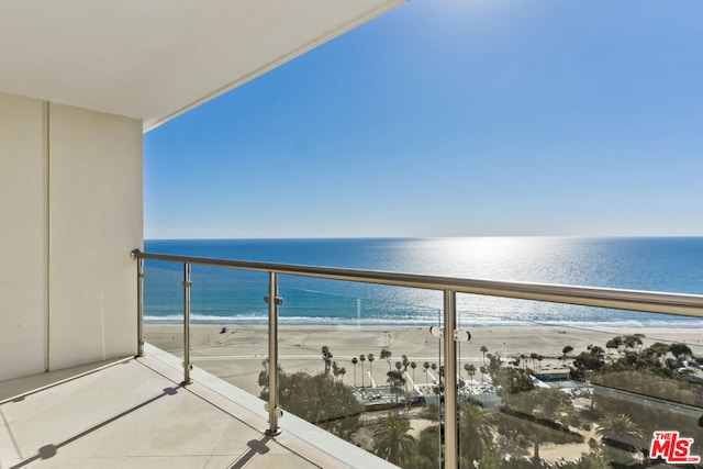 balcony with a beach view and a water view