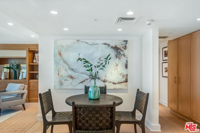 dining area featuring light wood-type flooring