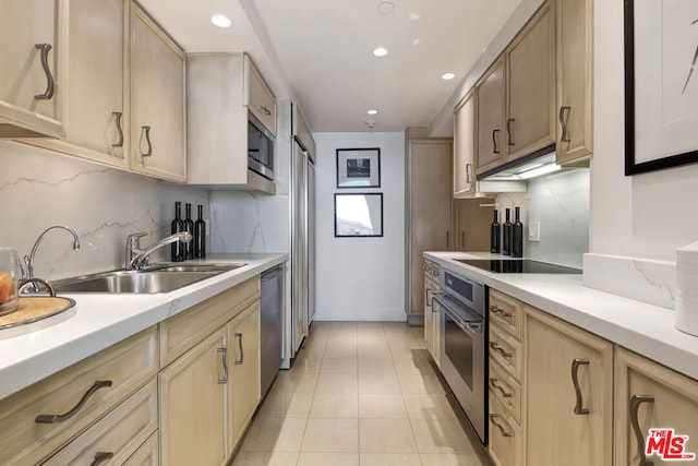 kitchen featuring decorative backsplash, sink, light tile patterned floors, and stainless steel appliances