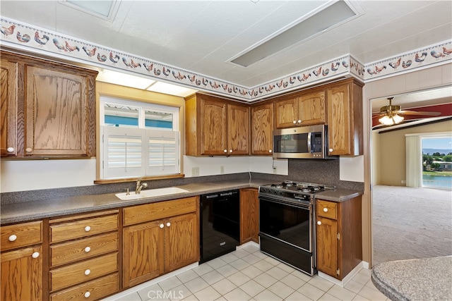 kitchen featuring black appliances, ceiling fan, light colored carpet, and sink