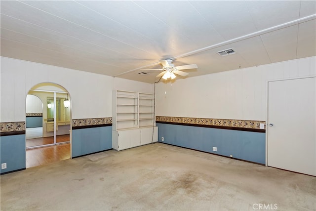 carpeted spare room with ceiling fan