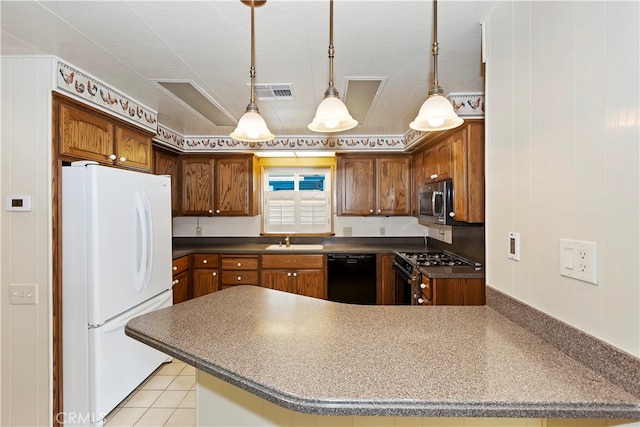 kitchen with pendant lighting, light tile patterned floors, sink, kitchen peninsula, and appliances with stainless steel finishes