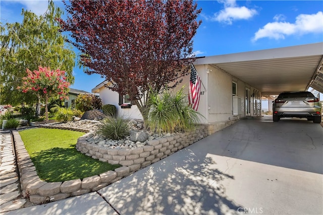 view of property exterior featuring a lawn and a carport