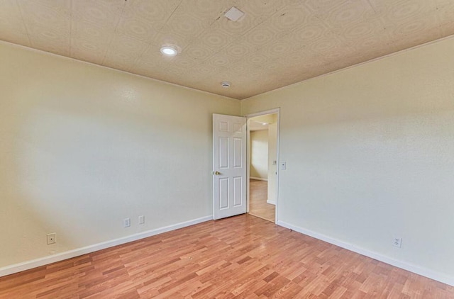 spare room featuring light wood-type flooring