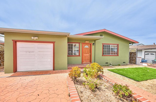 single story home with a front yard and a garage