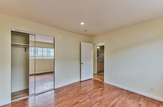 unfurnished bedroom featuring a closet and wood-type flooring