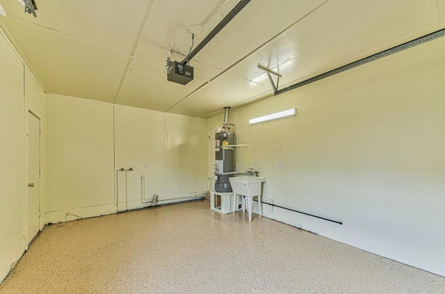 garage featuring secured water heater, sink, and a garage door opener