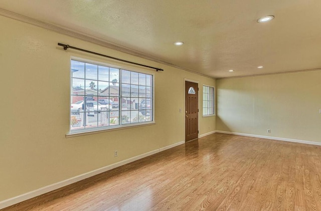 interior space featuring light wood-type flooring and crown molding