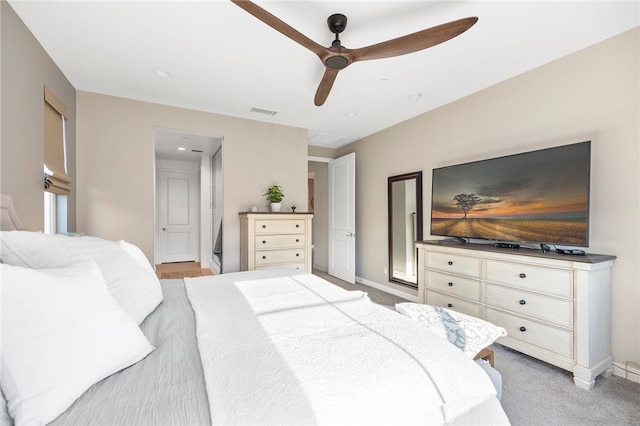 bedroom featuring light carpet, baseboards, visible vents, and a ceiling fan