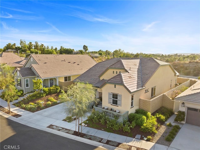 view of front of house featuring a garage, fence, concrete driveway, and stucco siding