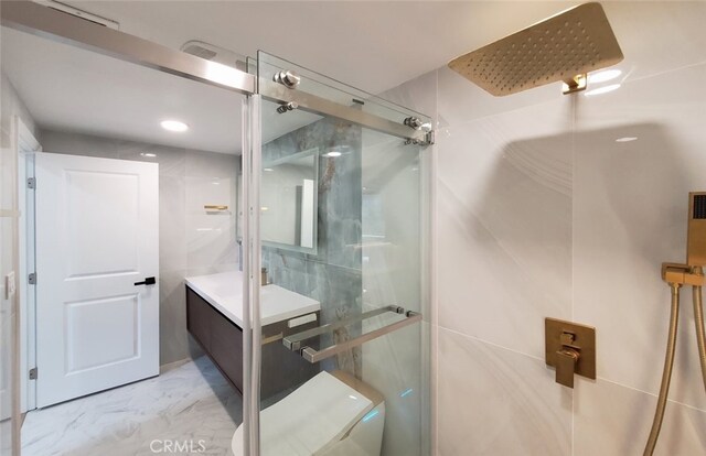 bathroom with vanity and a shower with shower door