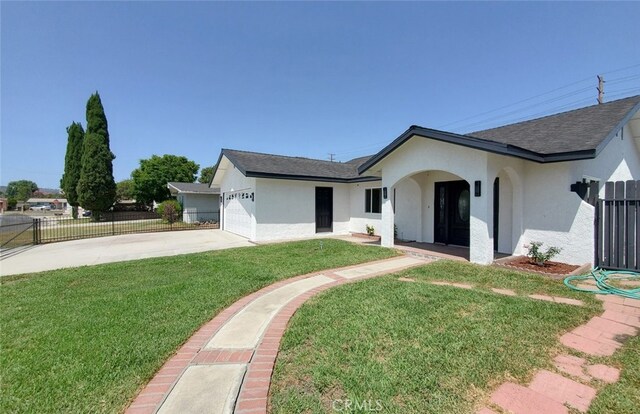 view of front of property featuring a garage and a front yard