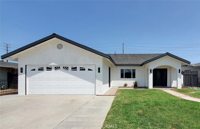 single story home with a garage and a front lawn