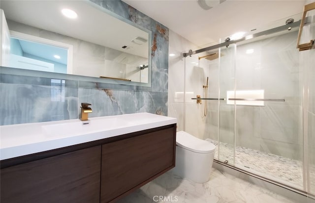 bathroom featuring vanity, a shower with door, lofted ceiling, toilet, and tile walls