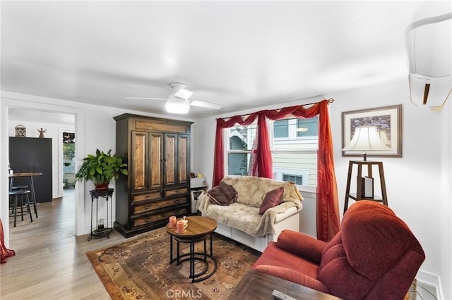 living room featuring ceiling fan and hardwood / wood-style flooring