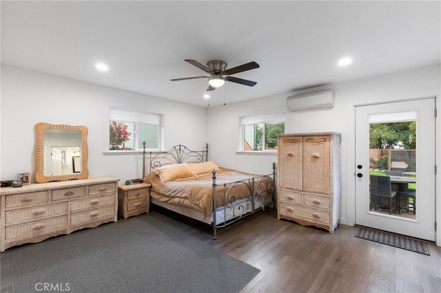 bedroom with access to outside, dark hardwood / wood-style floors, ceiling fan, and a wall mounted air conditioner