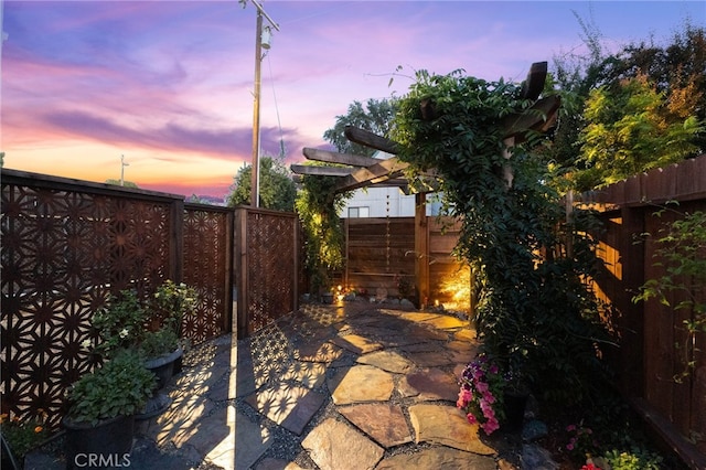 view of patio terrace at dusk