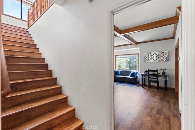 stairway featuring hardwood / wood-style floors, coffered ceiling, and beam ceiling