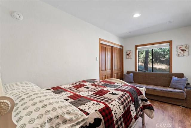 bedroom with light wood-type flooring and a closet