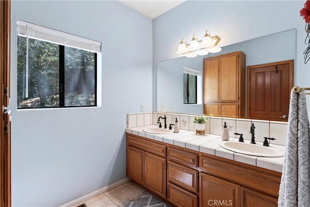 bathroom featuring vanity, tasteful backsplash, and tile patterned floors