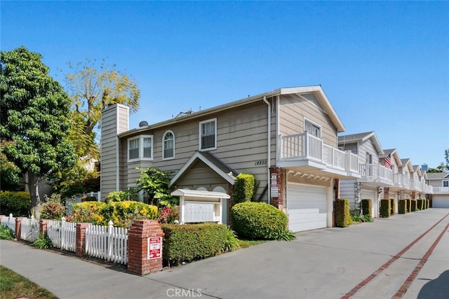 view of home's exterior featuring a balcony and a garage