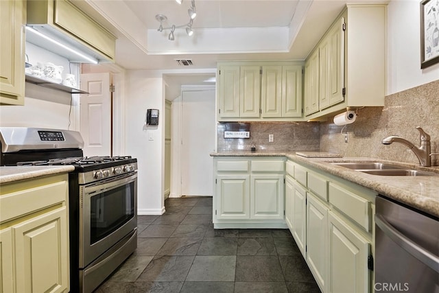 kitchen featuring a raised ceiling, decorative backsplash, sink, and appliances with stainless steel finishes