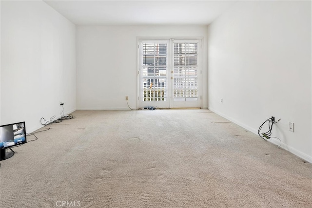 unfurnished room featuring light carpet