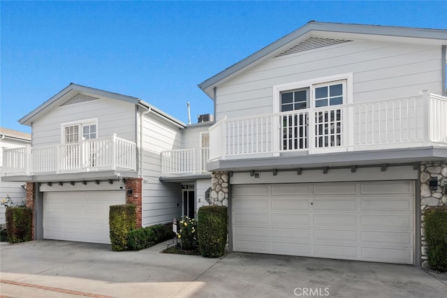 view of property featuring a balcony and a garage