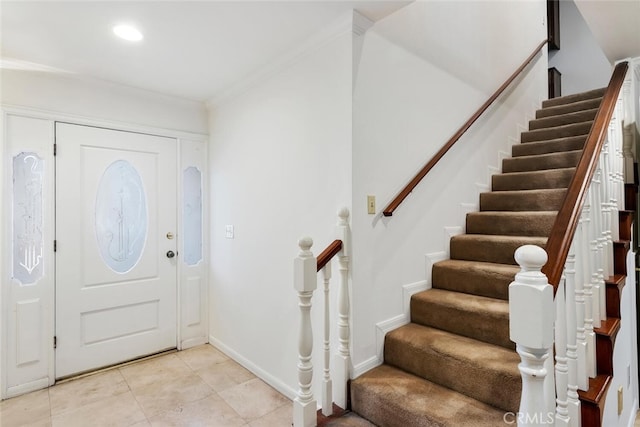 tiled entrance foyer featuring ornamental molding