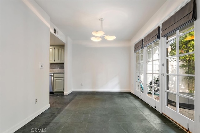 unfurnished dining area with a notable chandelier