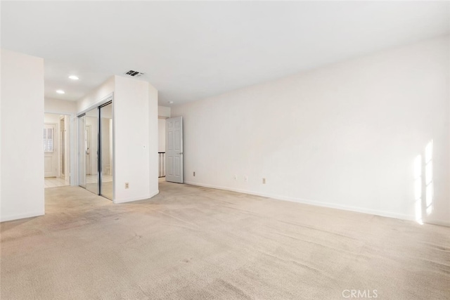 unfurnished room featuring light colored carpet