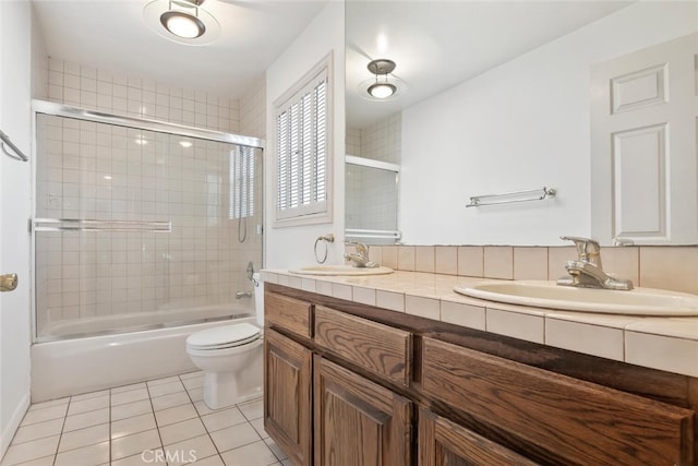 full bathroom featuring tile patterned flooring, vanity, enclosed tub / shower combo, and toilet