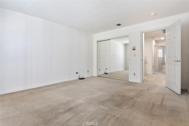 empty room with light colored carpet