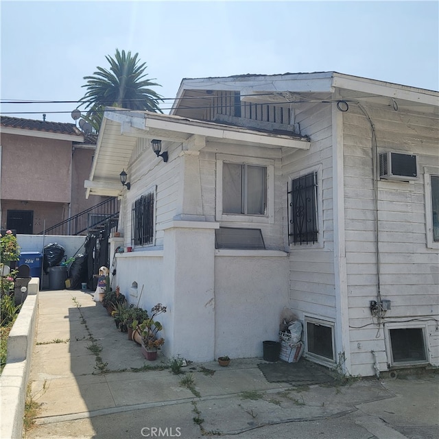 view of side of property featuring a wall mounted air conditioner