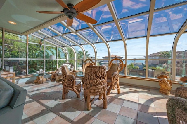 sunroom with ceiling fan and vaulted ceiling