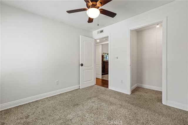 unfurnished bedroom with carpet floors, ceiling fan, and a closet