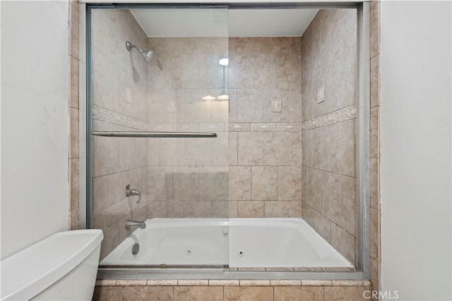 bathroom featuring shower / bath combination with glass door and toilet