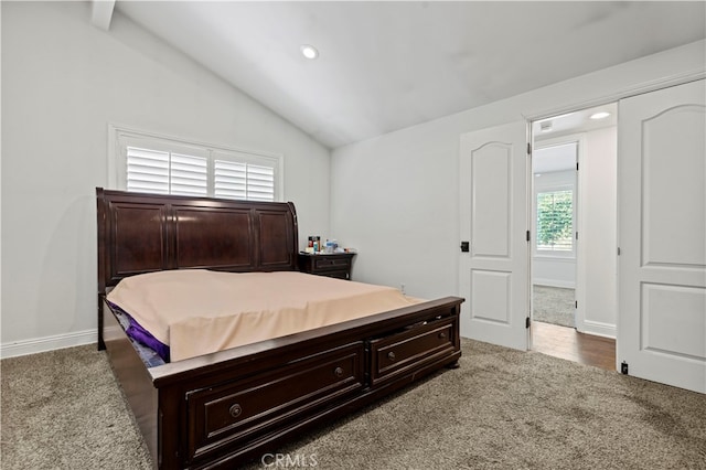 carpeted bedroom featuring lofted ceiling