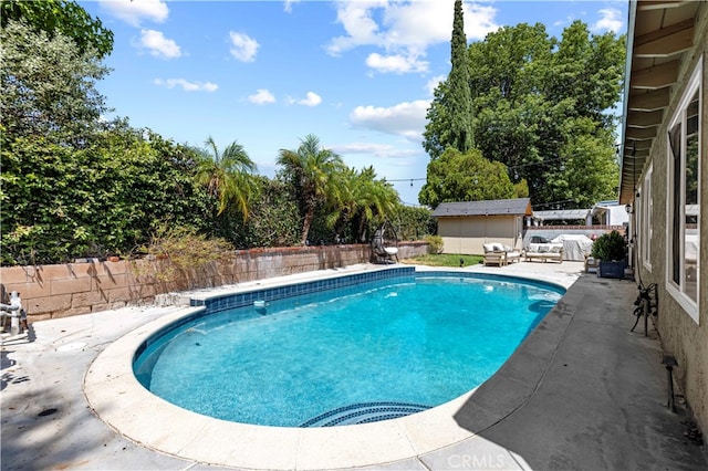 view of swimming pool featuring an outdoor structure and a patio area