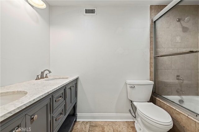 full bathroom featuring shower / bath combination with glass door, vanity, and toilet